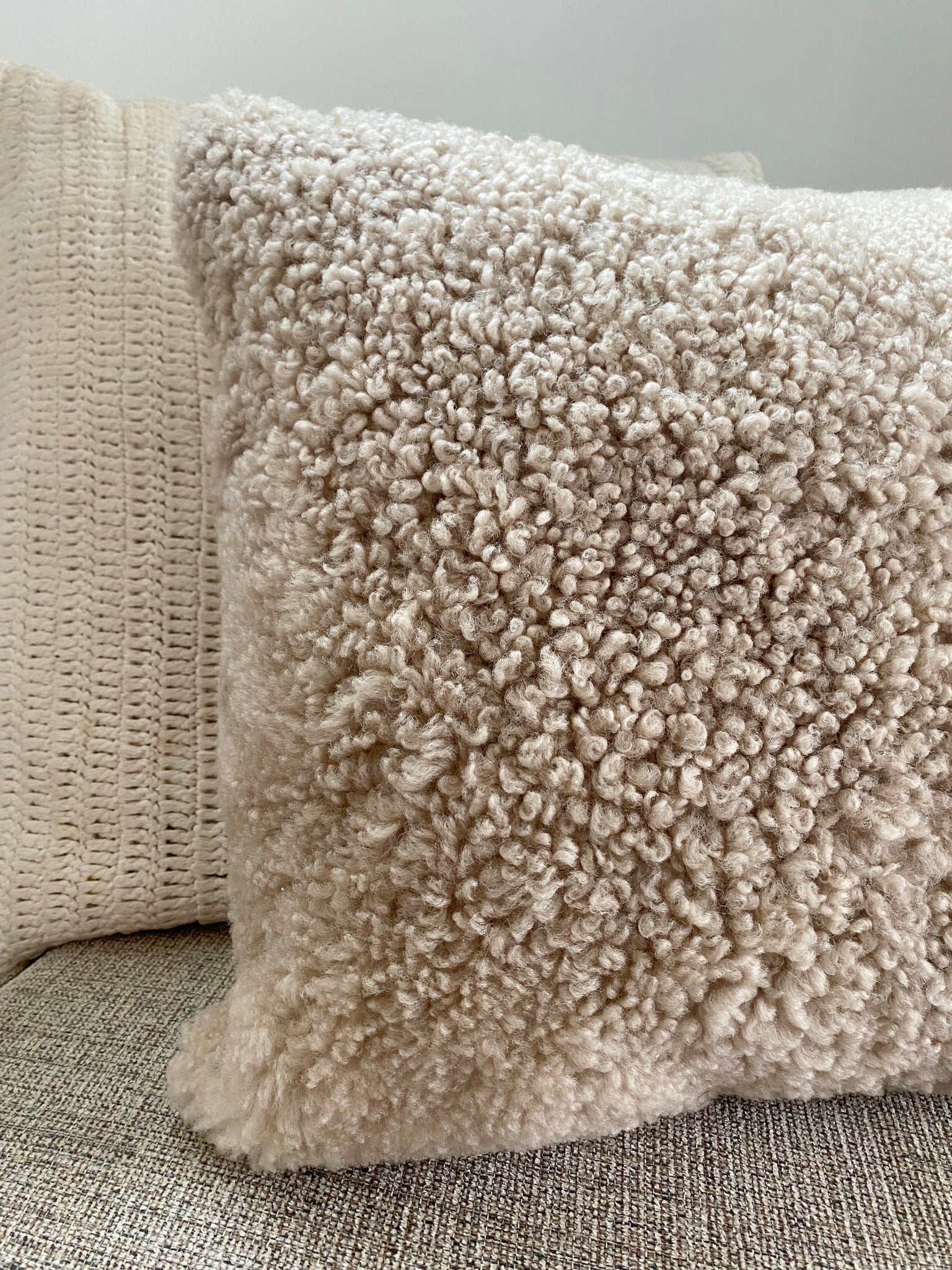 Close-up of tan shearling sheepskin pillow