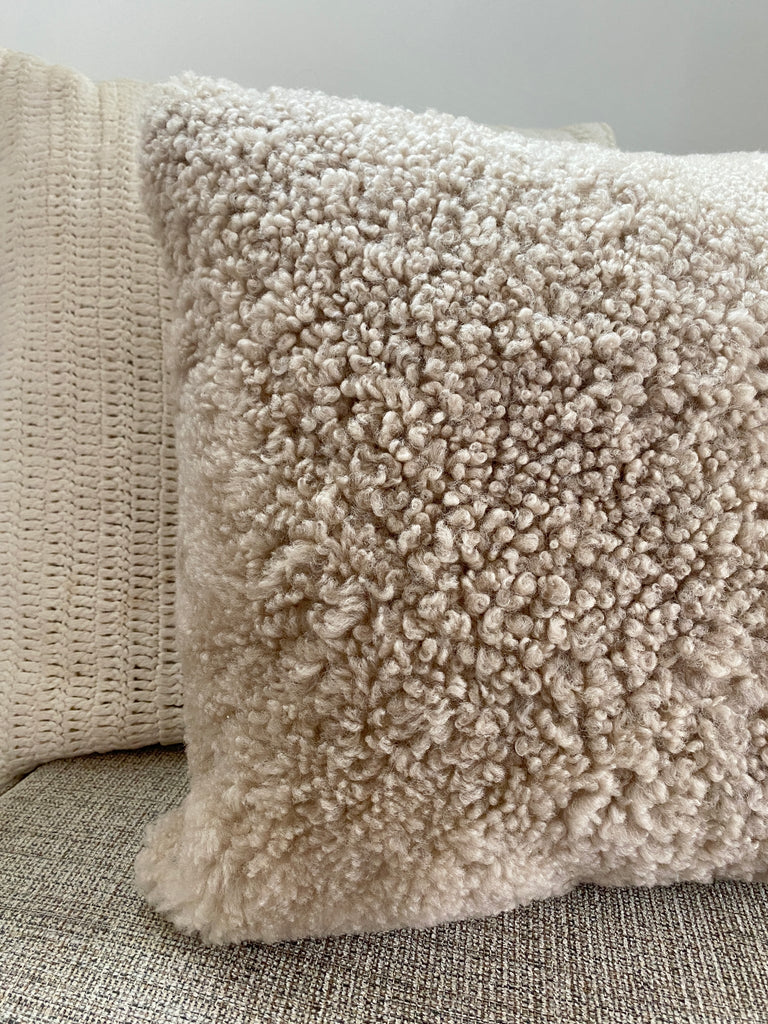 Close-up of tan shearling sheepskin pillow