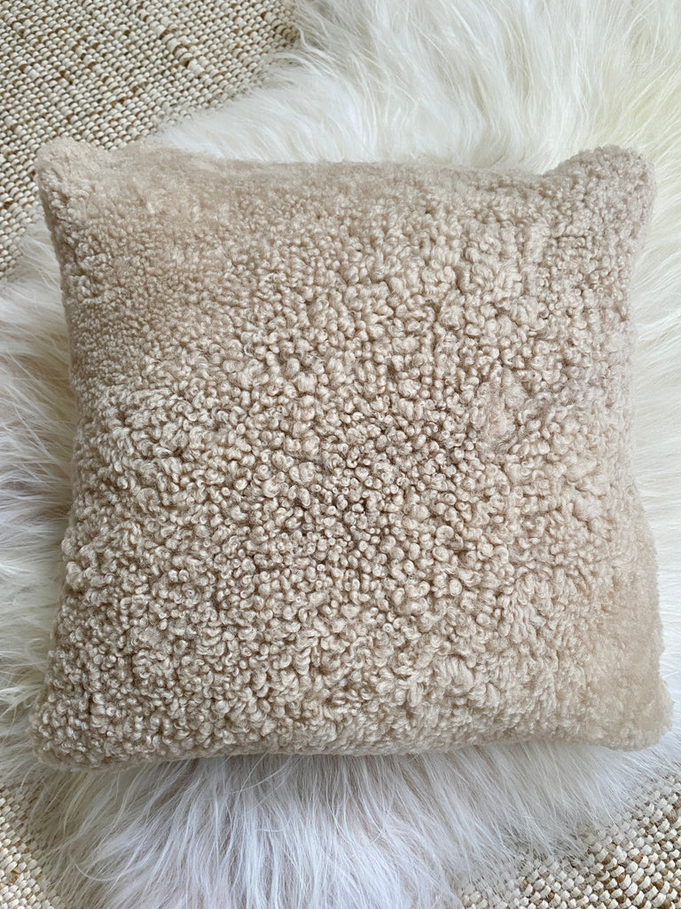 Top-view of tan shearling sheepskin pillow