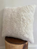 Side-view of ivory shearling sheepskin pillow