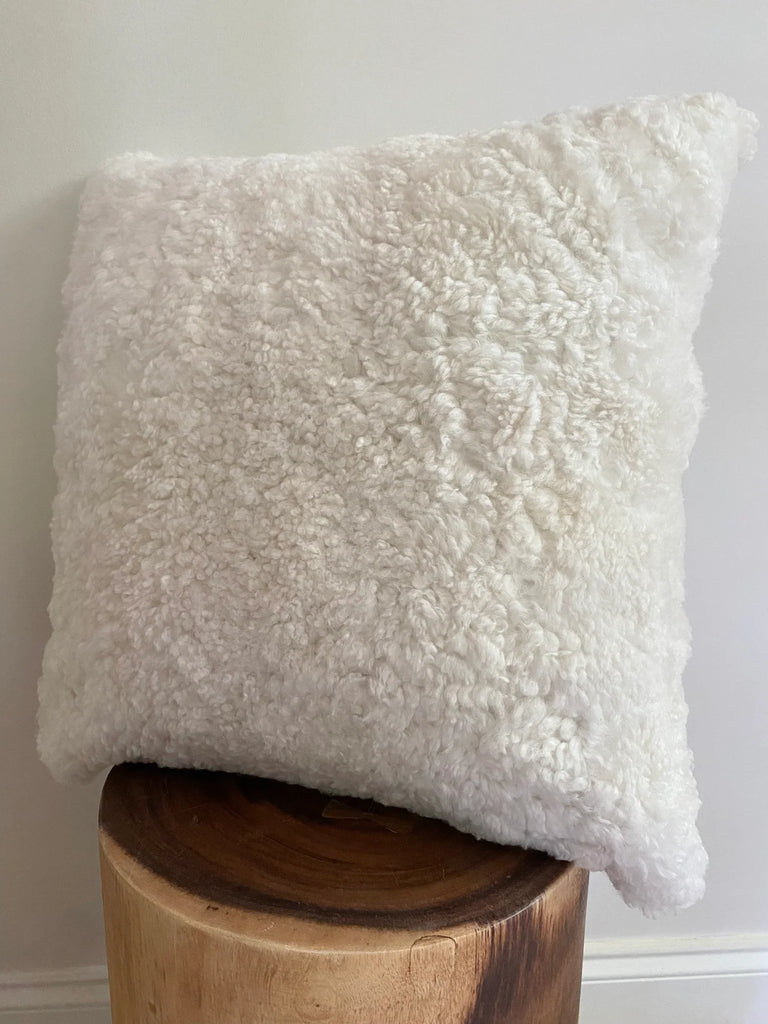 Side-view of ivory shearling sheepskin pillow