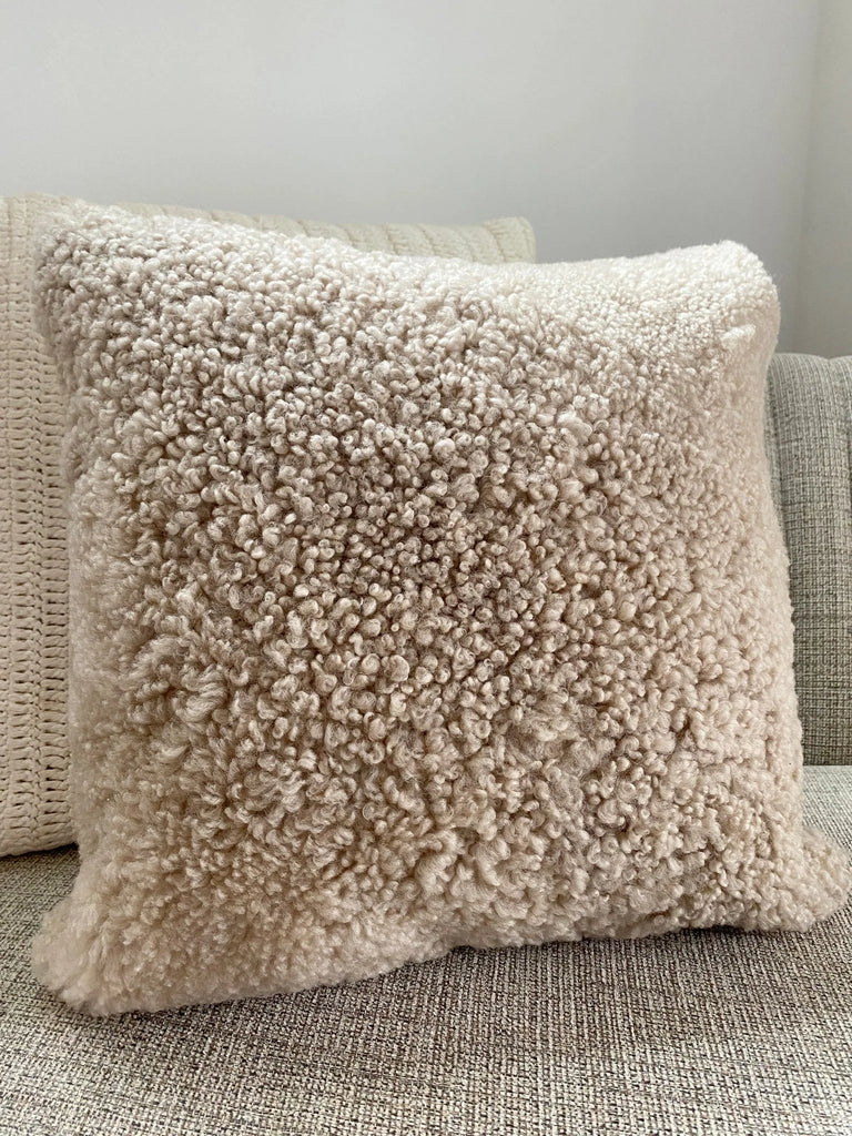 Close-up of ivory shearling sheepskin pillow