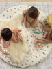 Children playing on a bright ivory nursery sheepskin