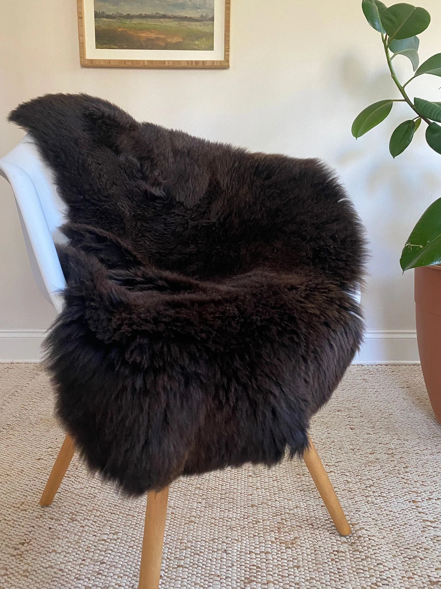 Dark Brown sheepskin rug draped over a chair 