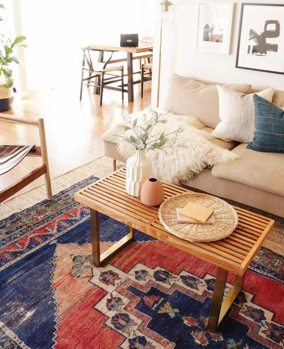 Living room with a wooden coffee table, sofa, and classic ivory sheepskin