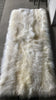 Top-view of creamy ivory sheepskin bed cover rug