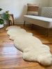 Double shorn ivory sheepskin on a wooden floor 
