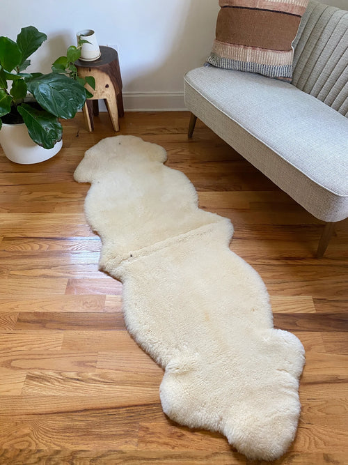 Double shorn ivory sheepskin on a wooden floor 
