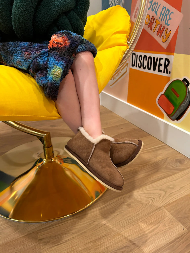 Person wearing extra roomy genuine sheepskin slipper