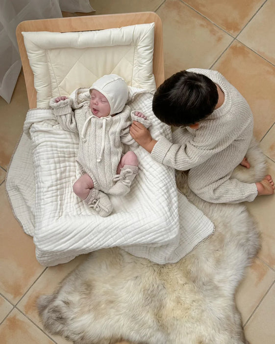 Newborn baby in a white outfit family bundles