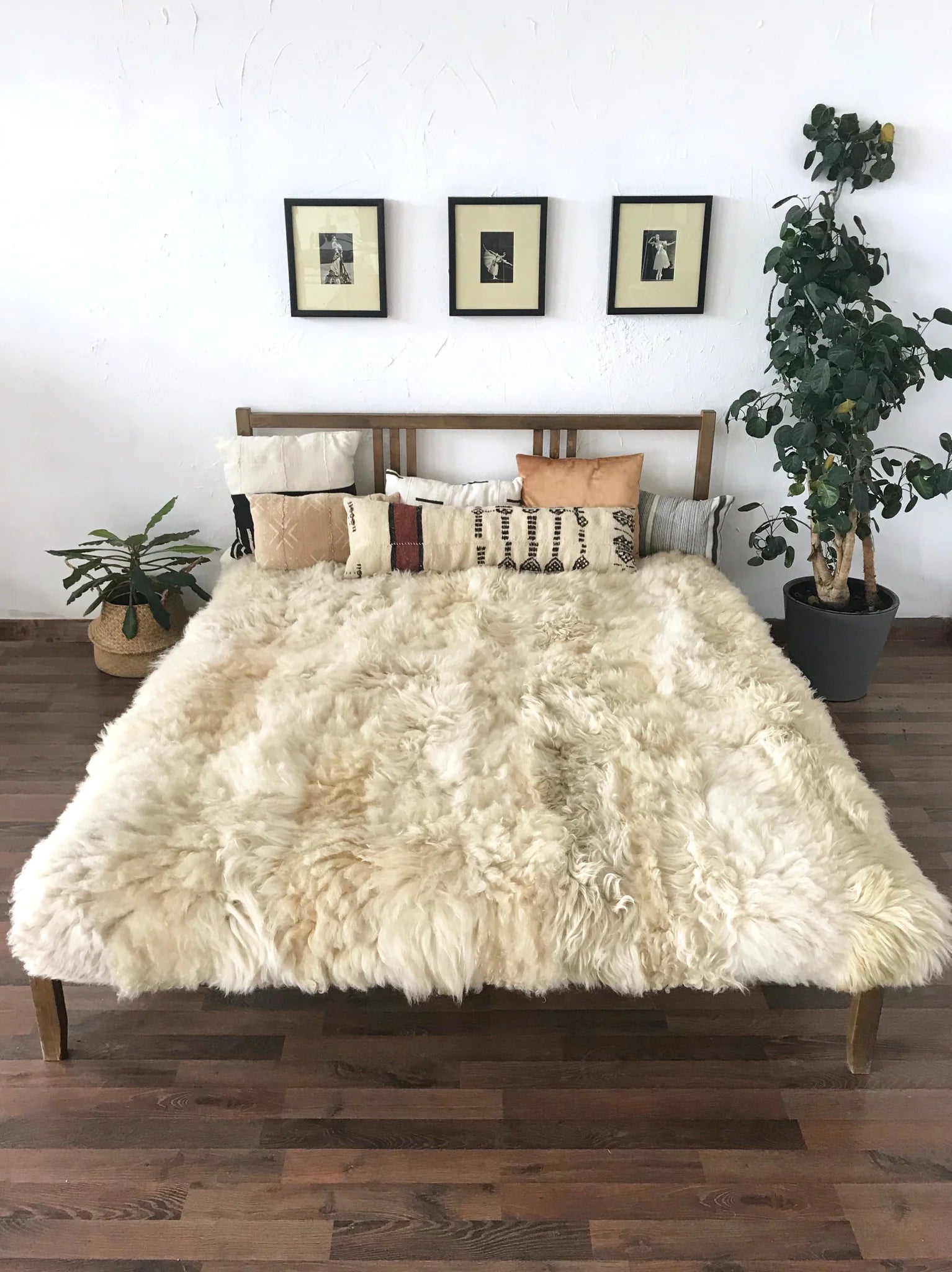 Bed with ivory plush sheepskin blanket