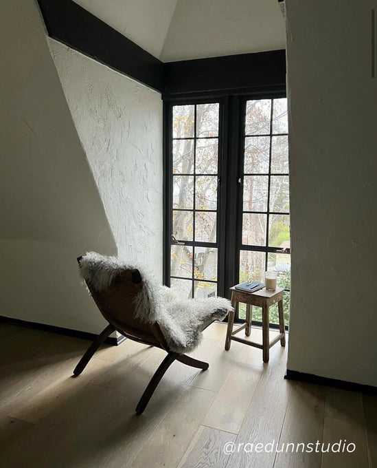 Modern interior with a chair draped with longhaired ivory gotland