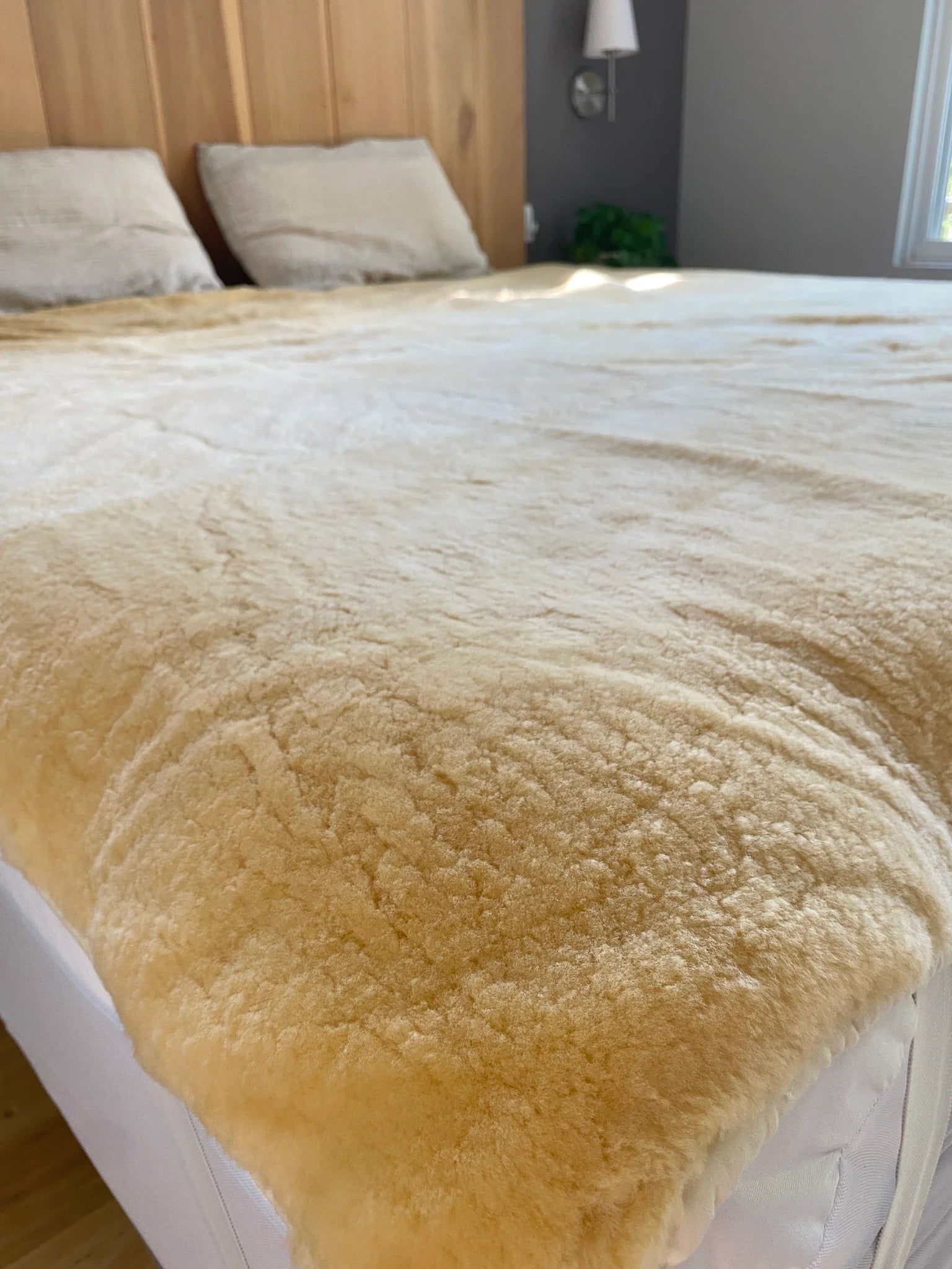 Bed with medical grade sheepskin mattress cover side view
