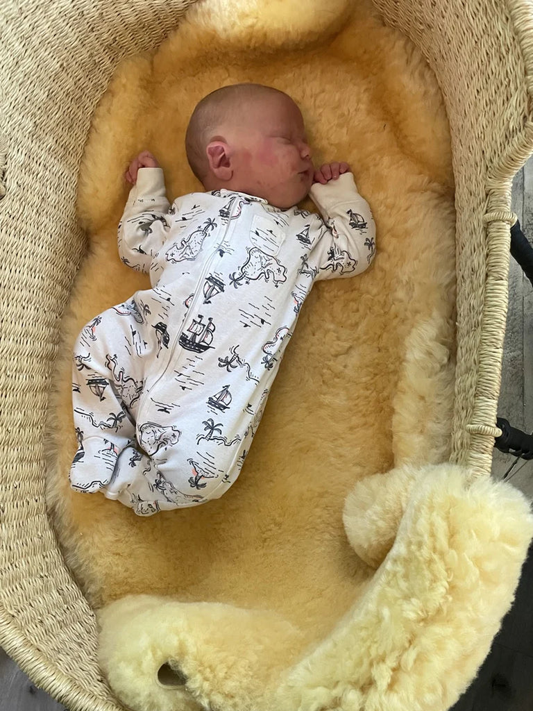 Baby lying on medical relugan nursery sheepskin 