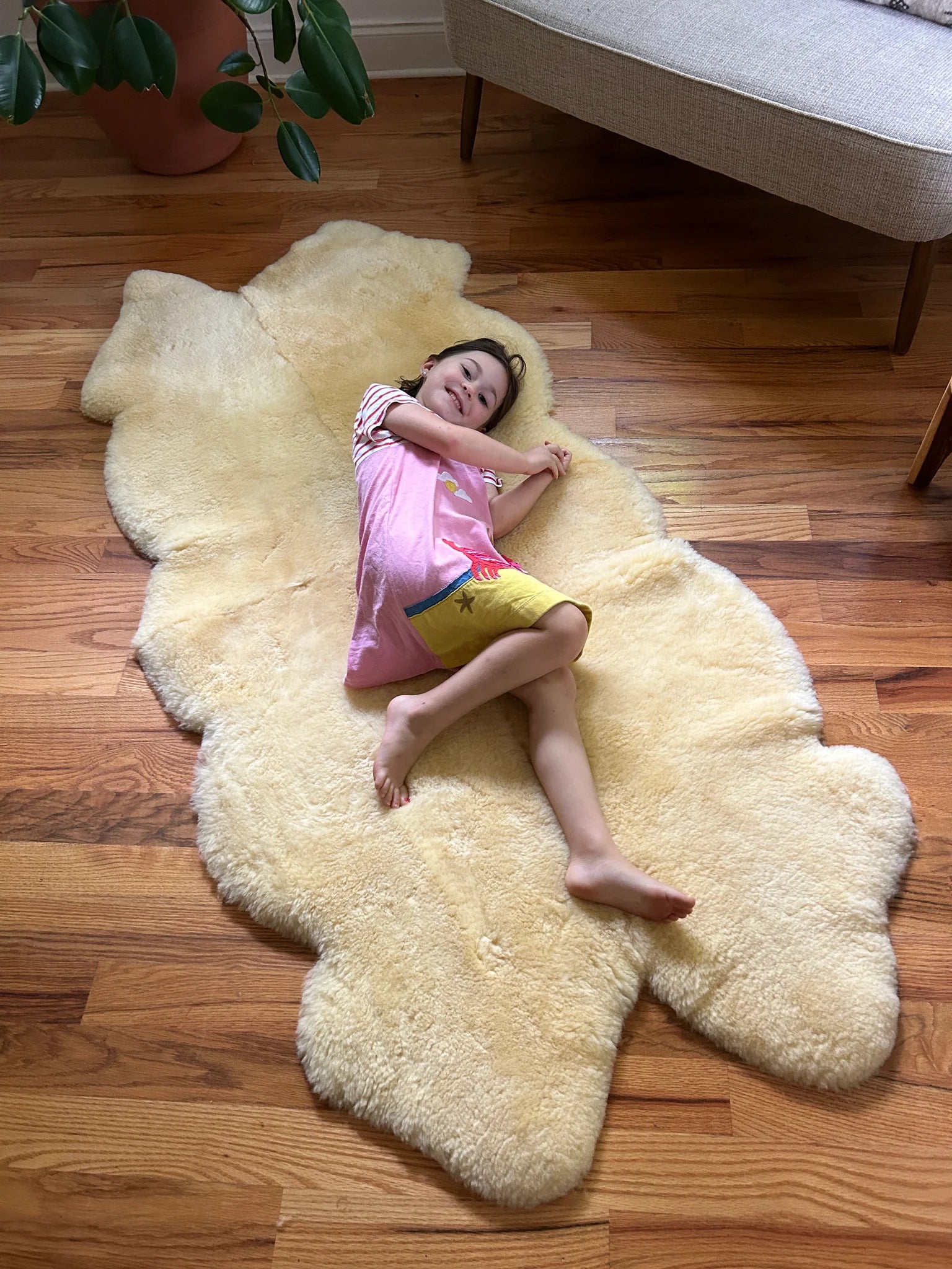 Child lying on a medical relugan quad sheepskin