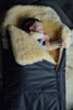 Close-up of soft cream sheepskin lining inside black sleeping bag