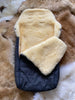 Close-up of soft cream sheepskin lining inside black sleeping bag