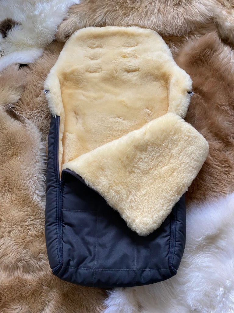 Close-up of soft cream sheepskin lining inside black sleeping bag