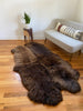 plush rich brown sheepskin quad on a wooden floor 