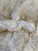 Detailed shot showing natural fur texture of ivory rug