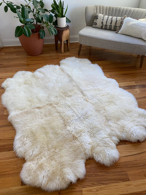 Sheepskin rug styled under a coffee table in a cozy living room