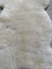 Close-up of soft plush texture of ivory sheepskin rug