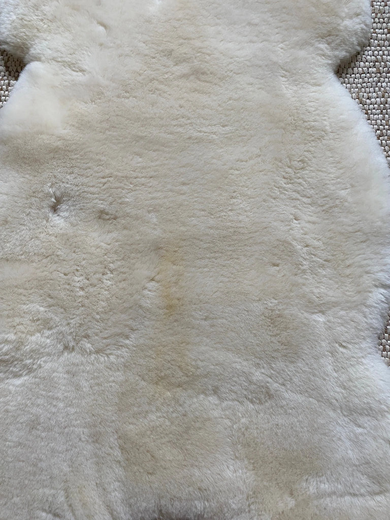 Close-up of soft plush texture of ivory sheepskin rug