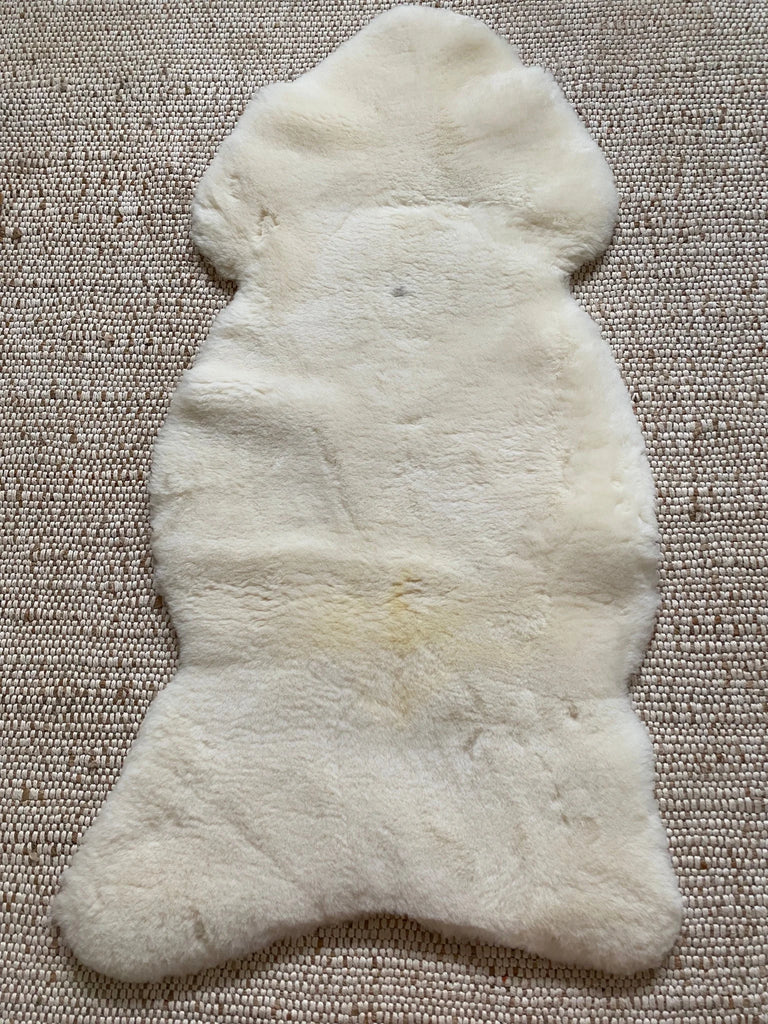 Top-down photo showing overall shape and size of ivory sheepskin rug