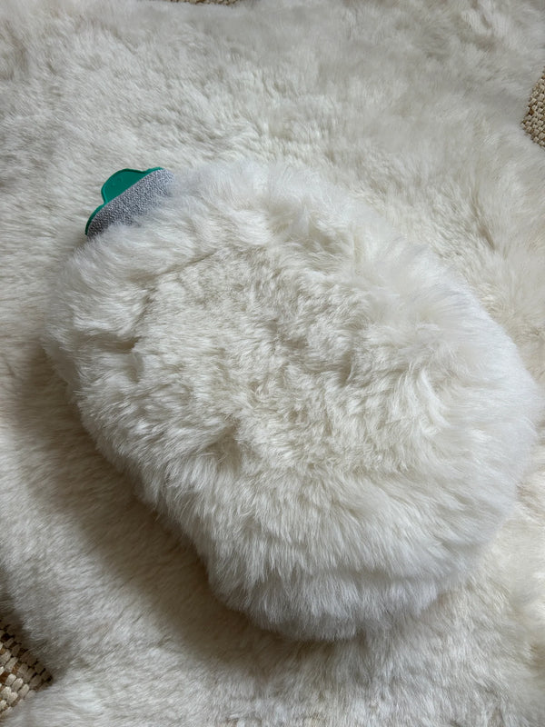 Close-up of sheepskin hot water bottle warmer