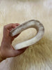 Hand holding a curved, sheepskin insoles