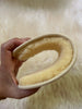 Hand holding a curved sheepskin insoles