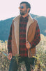 Man wearing a plaid shirt, brown sheepskin mens vest