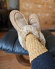 Person wearing sheepskin slippers