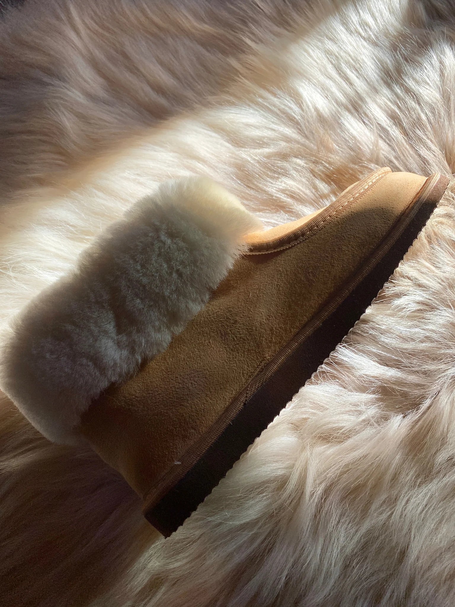 Side-view of sheepskin slippers with white fur