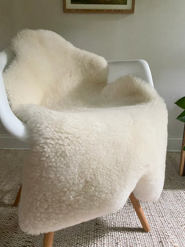 Short fur ivory sheepskin on a chair