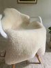 Short fur ivory sheepskin on a chair