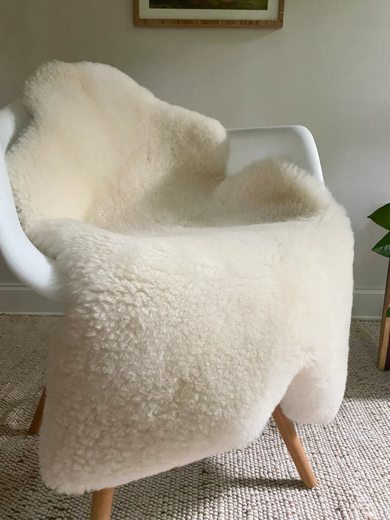 Short fur ivory sheepskin on a chair