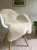 Short fur ivory sheepskin on a chair