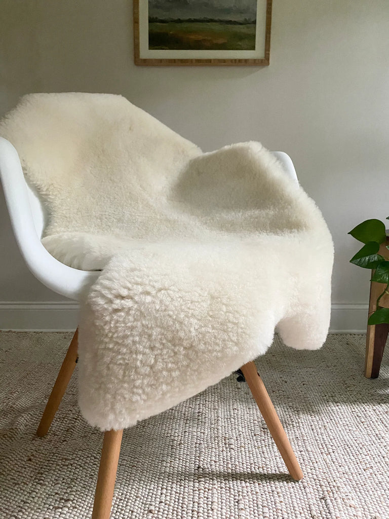 Short fur ivory sheepskin on a chair