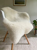 Short fur ivory sheepskin on a chair