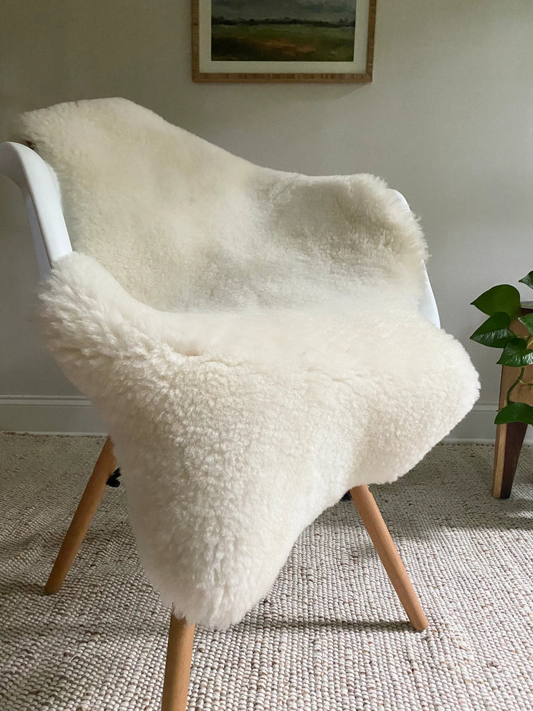Short fur ivory sheepskin on a chair
