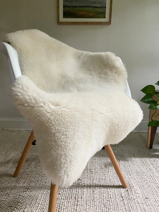 Short fur ivory sheepskin on a chair