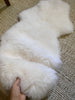 Small white nursery pelt on a textured carpet
