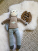 Knitted toy on a small white nursery pelt