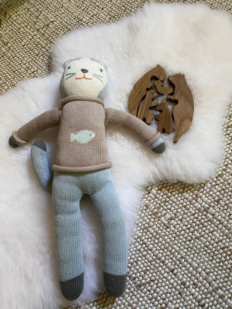 Knitted toy on a small white nursery pelt