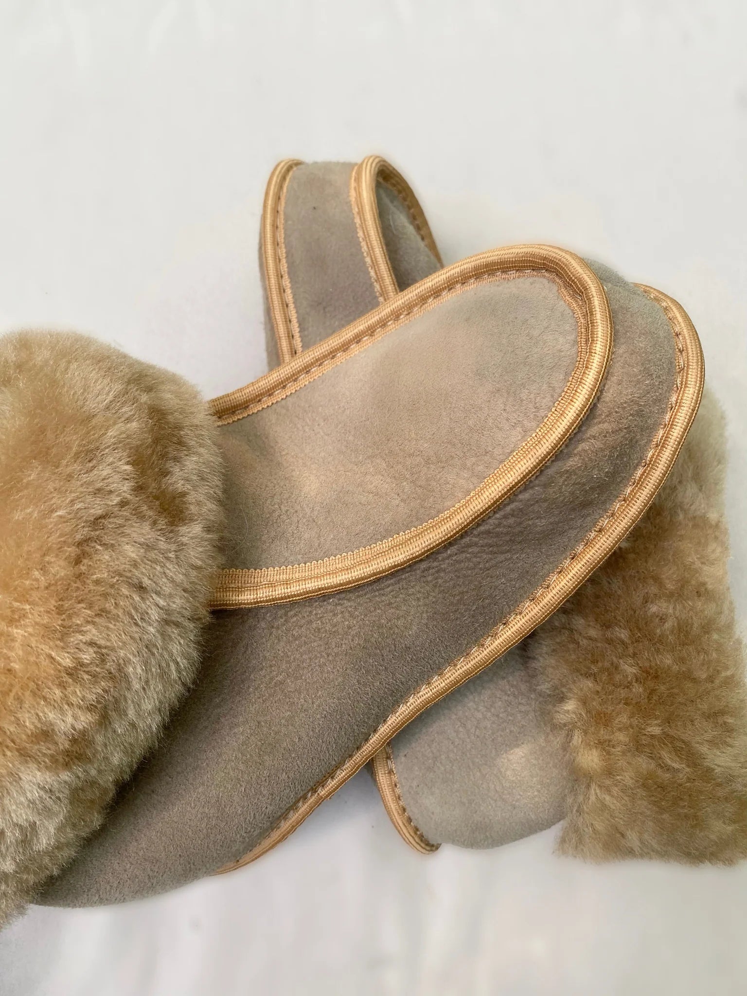 Pair of sheepskin slippers arranged side by side