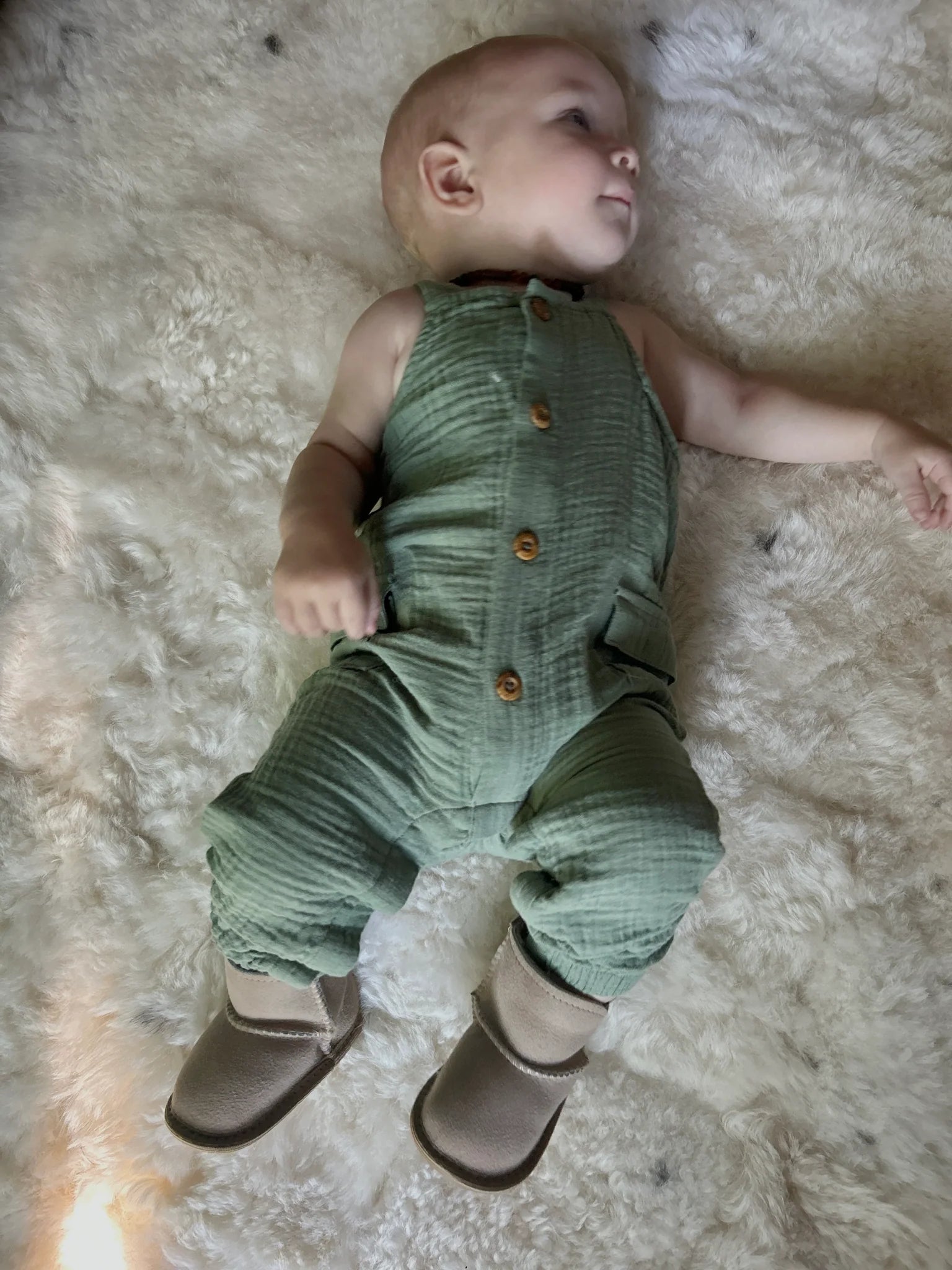 Top-view of baby wearing terra slipper sheepskin minimalist footwear for kids with tan fur