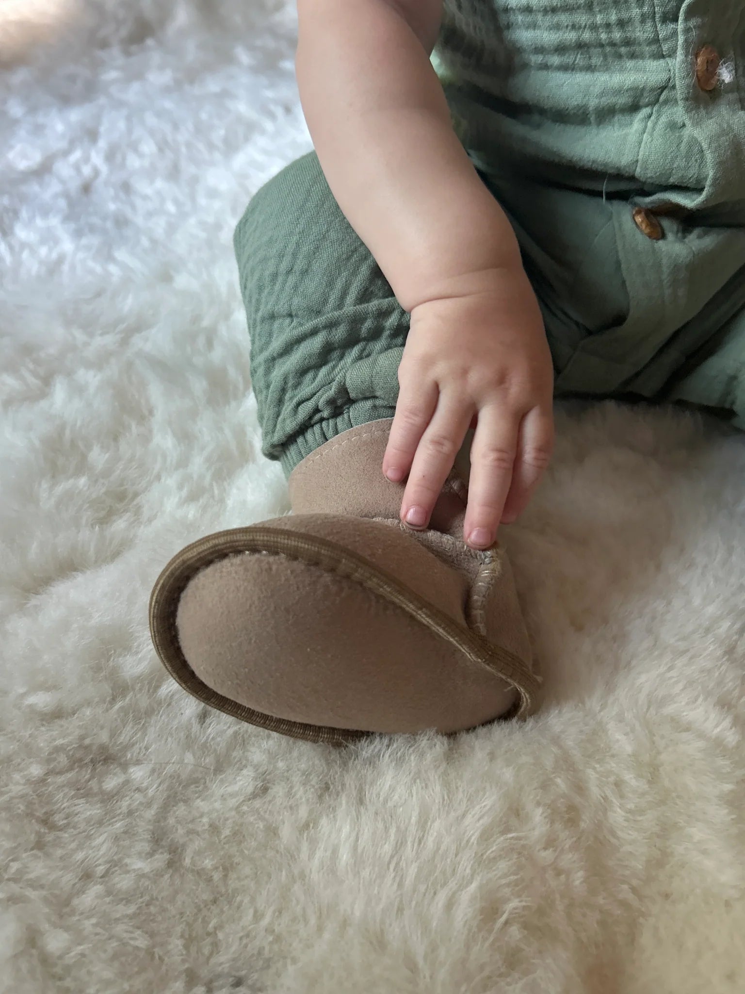 Close-up of terra slipper sheepskin minimalist footwear for kids with tan fur