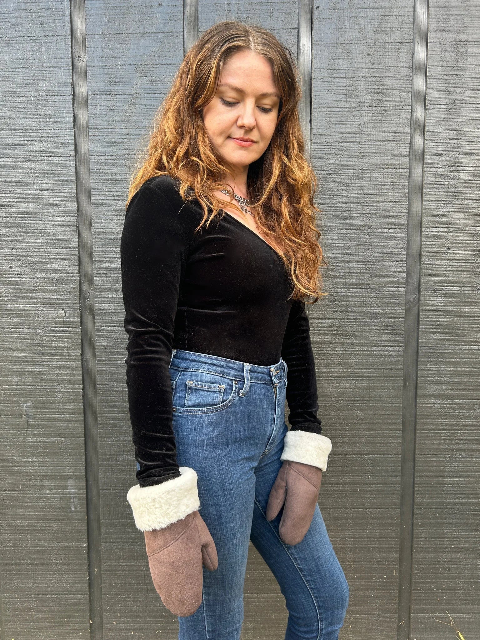 Woman wearing the haven sheepskin mitten in walnut