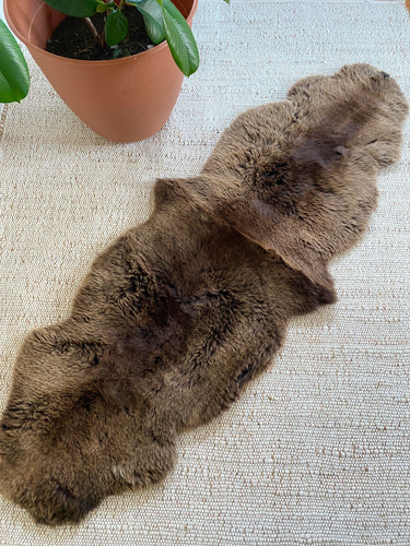 Vibrant brown double sheepskin on a textured surface 